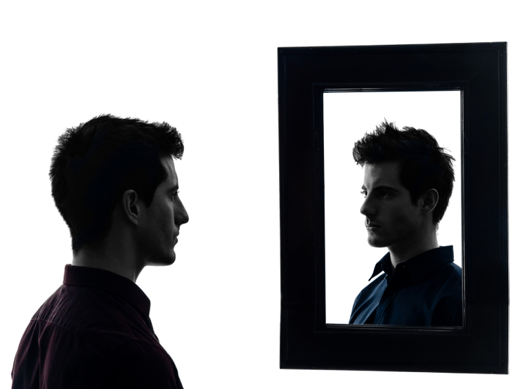 man in front of his mirror  in shadow  white background